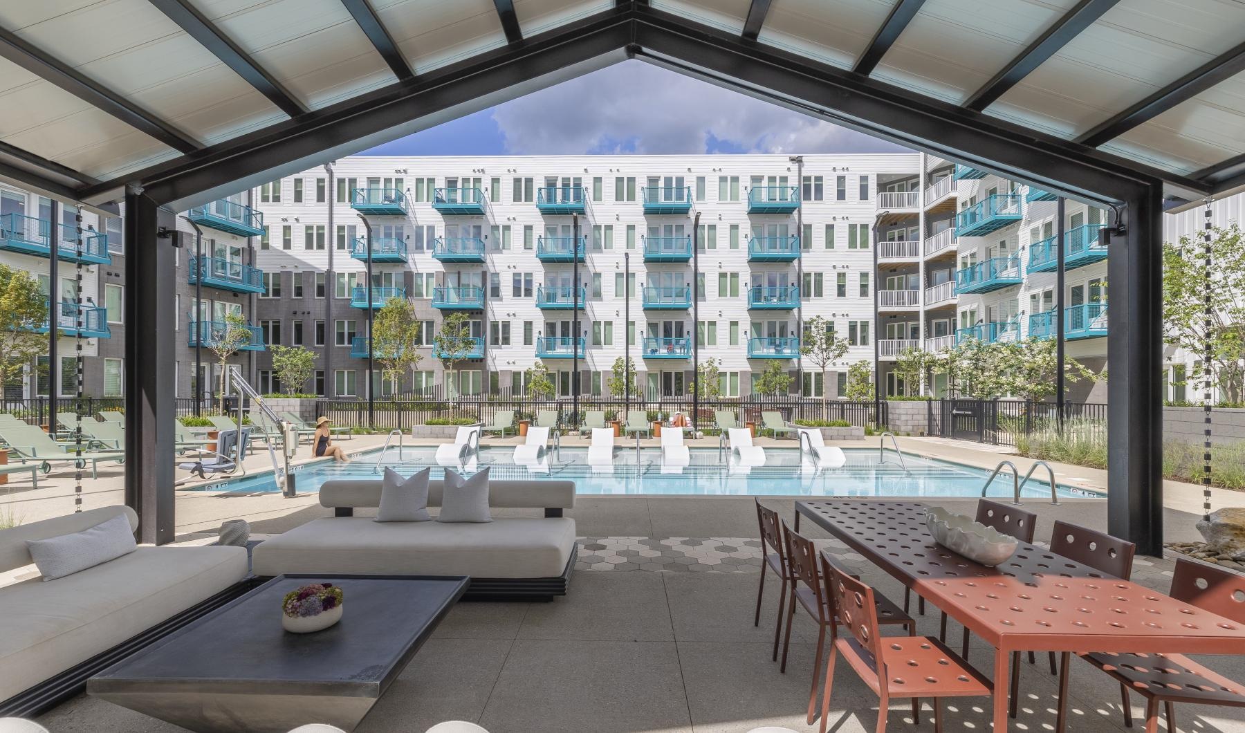 a covered poolside lounge space