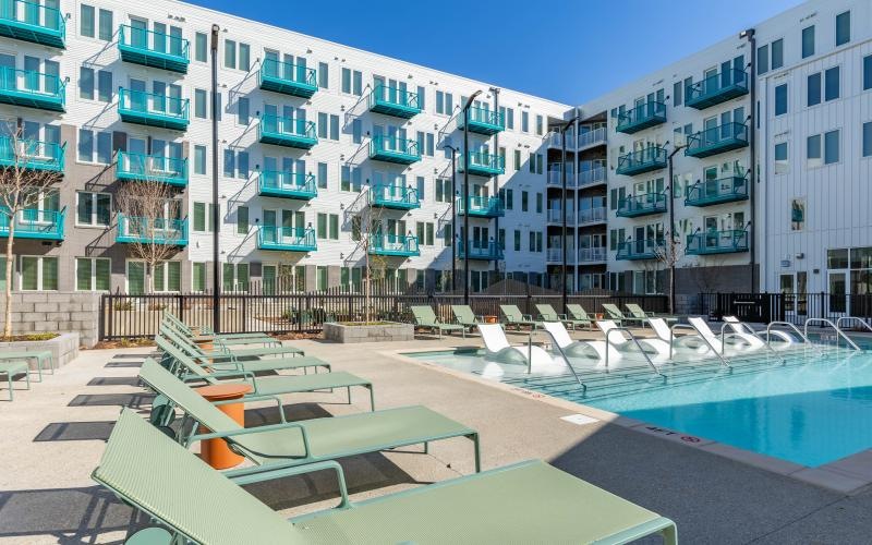 Resort-style swimming pool with lounge seating