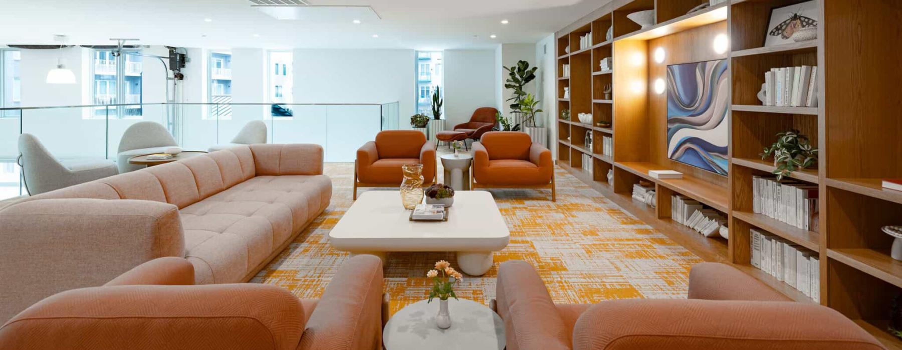 a room with a large bookcase and a table with chairs