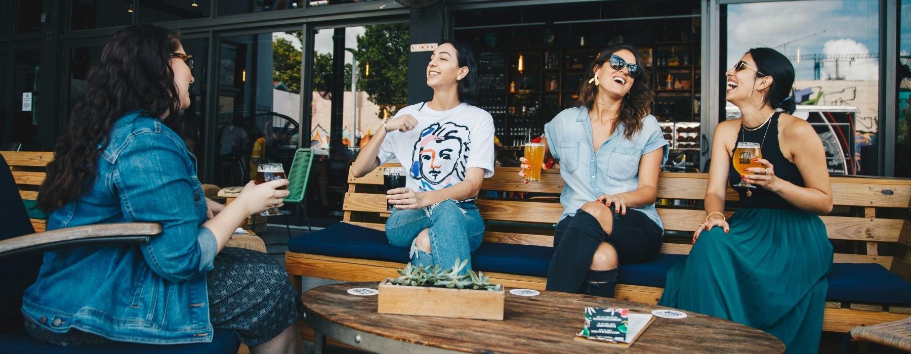 a group of women sitting at a table with drinks
